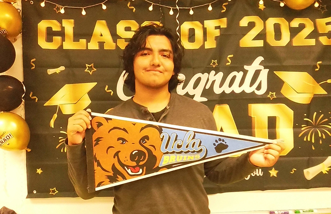 Luis holding UCLA pennant